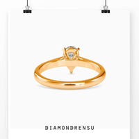Engagement pear shaped ring featuring a pear solitaire diamond and a handmade ring design.