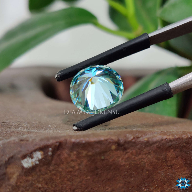 Cyan blue moissanite offered as loose moissanite with round brilliant cut.