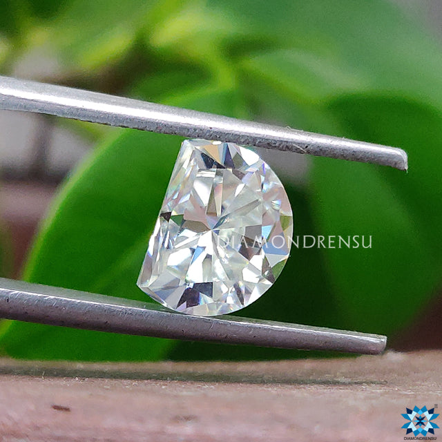 Off white moissanite shaped as Half Moon Cut loose moissanite.