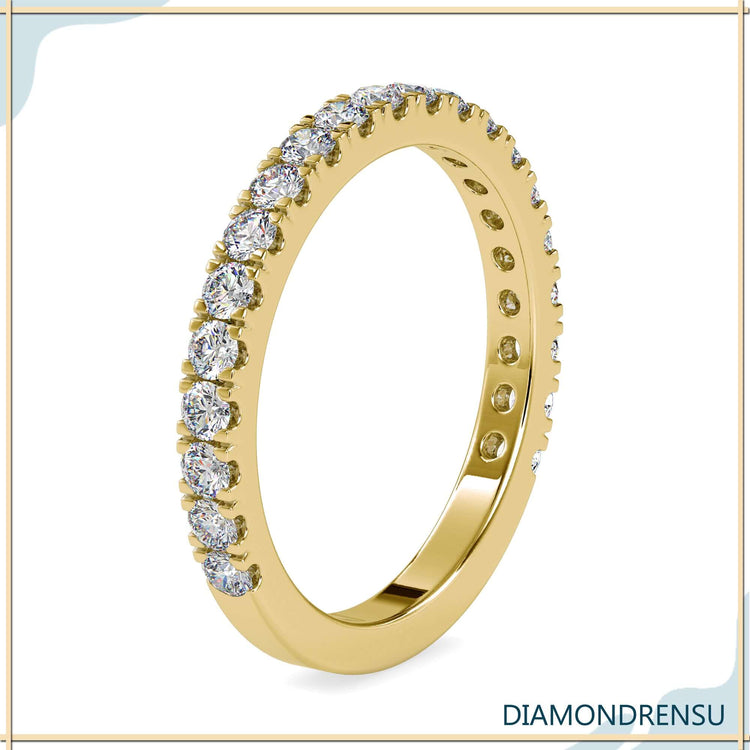 Round diamond wedding band with a gold pave setting for a timeless look.