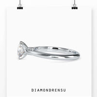 Solitaire diamond ring in yellow gold, featuring a round brilliant cut diamond with peek-a-boo accents for added sparkle.