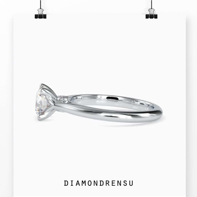 Solitaire diamond ring in yellow gold, featuring a round brilliant cut diamond with peek-a-boo accents for added sparkle.