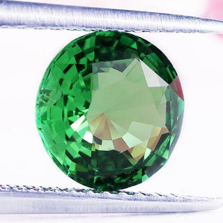 Round cut gemstone with vibrant tsavorite gemstone.