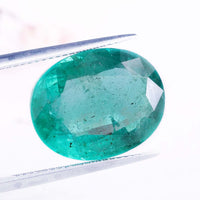 Emerald green gemstone paired with natural oval cut gemstone.