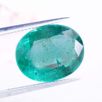 Emerald green gemstone paired with natural oval cut gemstone.