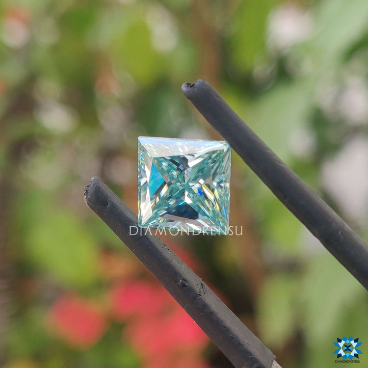 Loose stone listed as 1.75 carat princess cut moissanite and cyan blue moissanite.