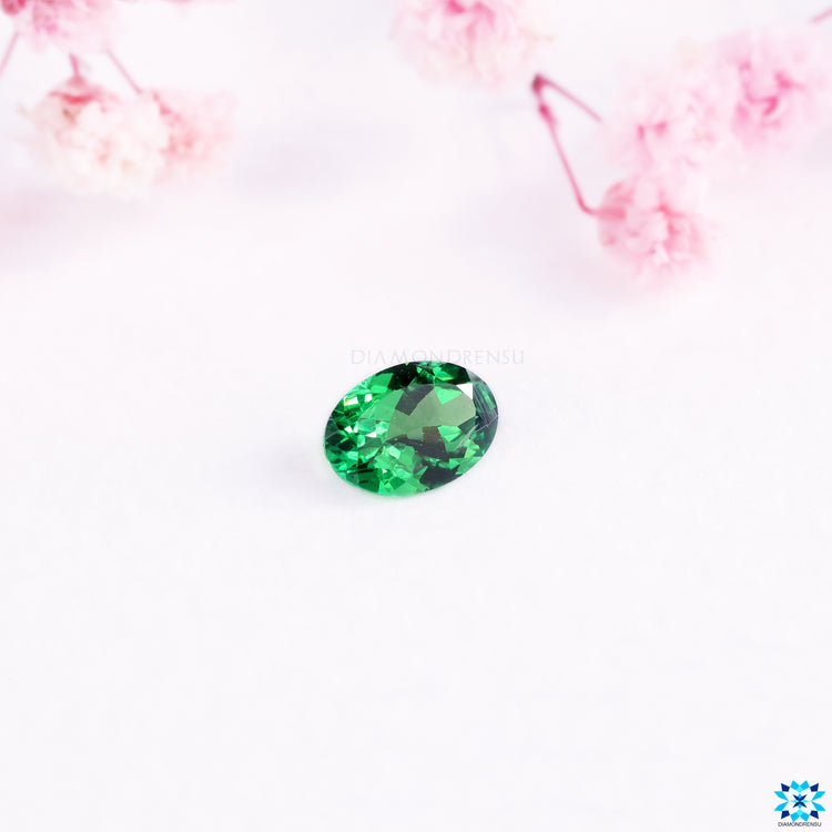 Tsavorite gemstone paired with oval cut gemstone.
