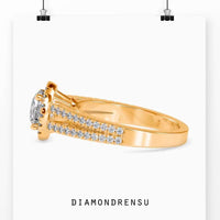 Split shank diamond ring with a round diamond halo and pave setting, perfect for engagements.