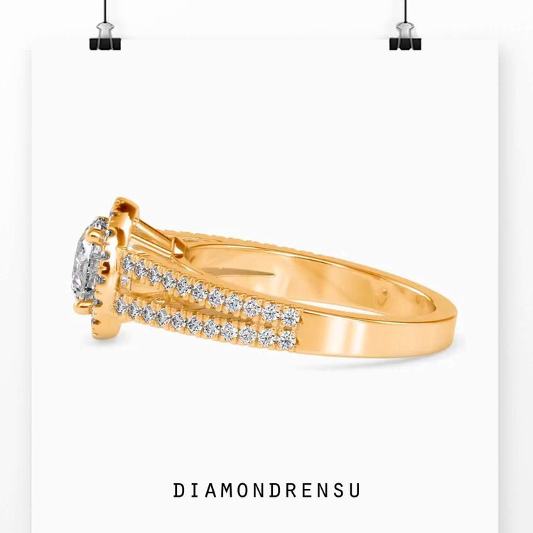 Split shank diamond ring with a round diamond halo and pave setting, perfect for engagements.