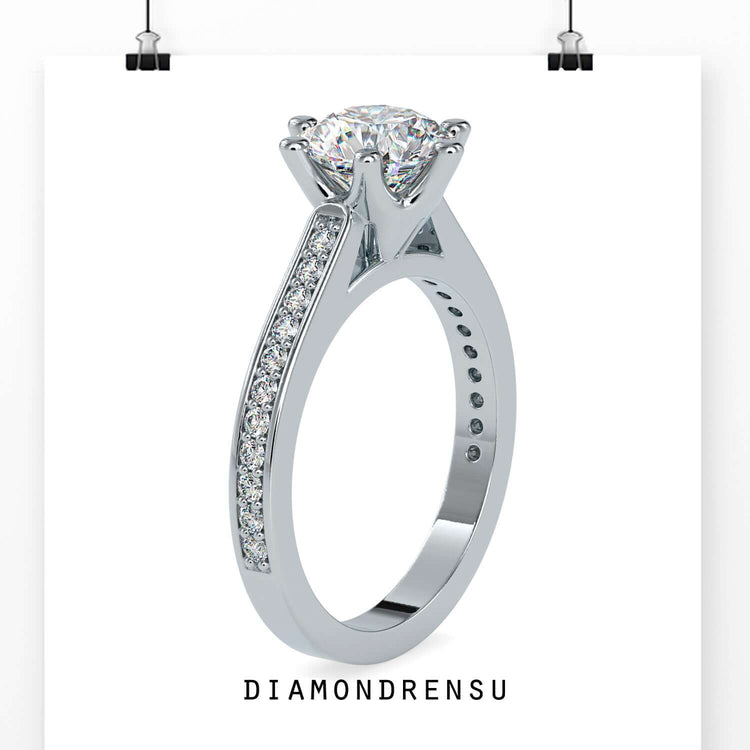 Round diamond engagement ring with a pave channel engagement ring setting for added sparkle.