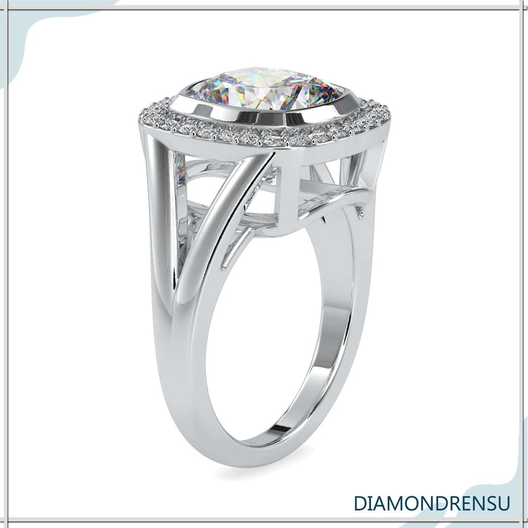 Cushion cut diamond with a halo and split ring shank, showcasing a brilliant design.