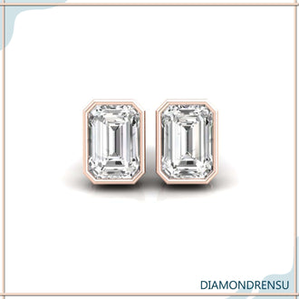 Sophisticated emerald cut diamond stud earrings with a bezel set for secure wear.