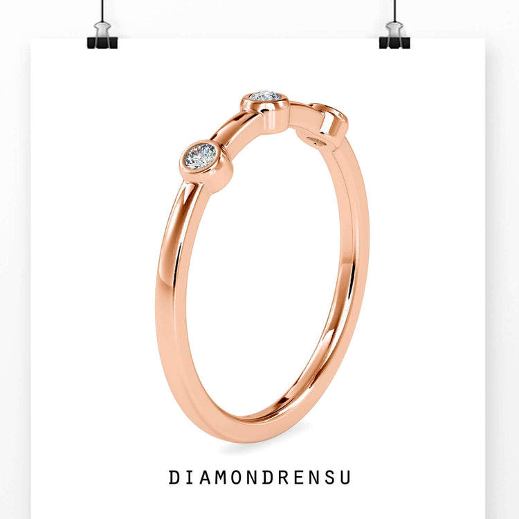 Bezel set eternity band with round diamonds in yellow gold