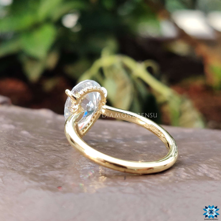 A bespoke handmade jewellery piece: a yellow gold wedding ring with a hidden halo ring design.