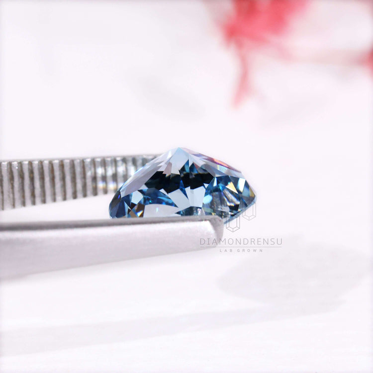 This blue diamond features a cushion cut and IGI certified lab grown quality.