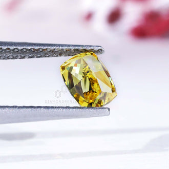0.70 carat loose elongated cushion yellow diamond.