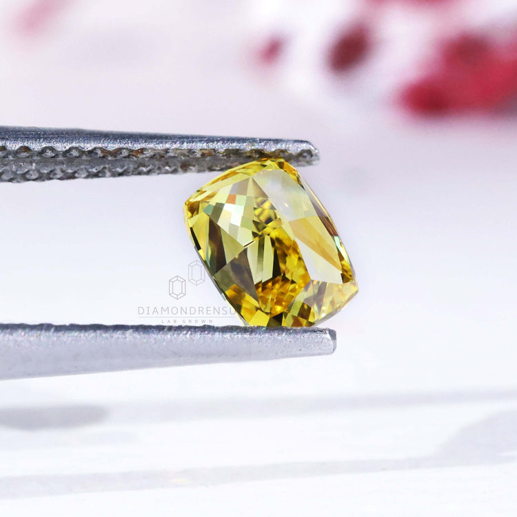 0.70 carat loose elongated cushion yellow diamond.