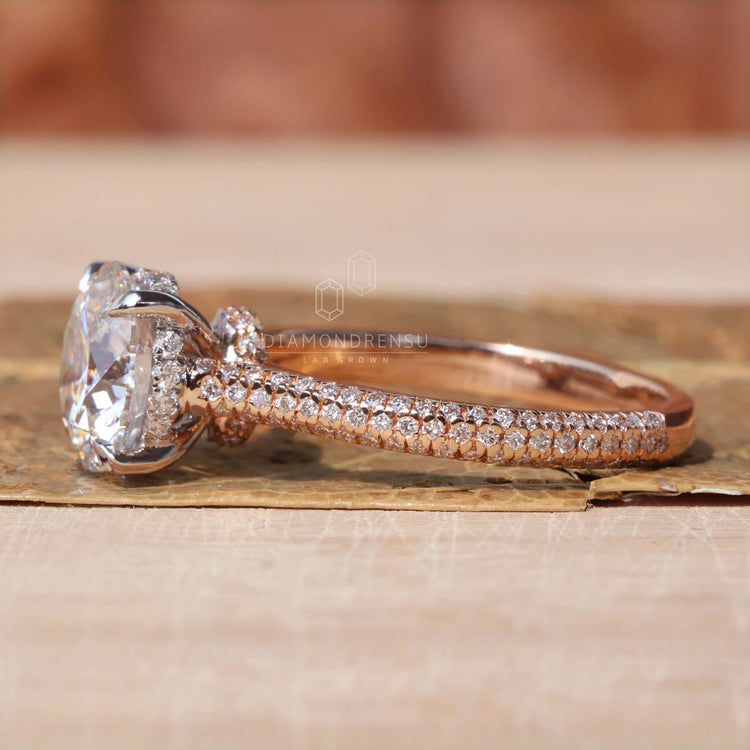 Round diamond engagement ring in white and rose gold.