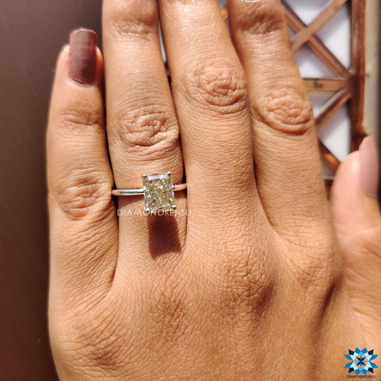 Moissanite solitaire ring with 4-prong tab prong settings.