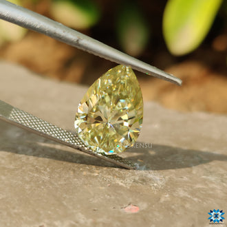 Pear Greenish Yellow Moissanite shown as a single loose stone.