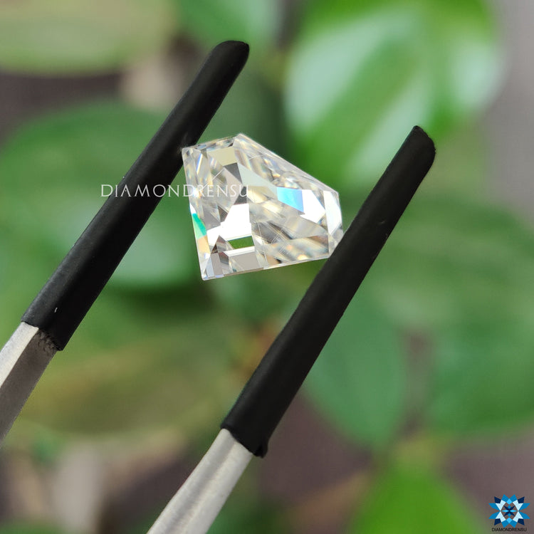 Diamond shape moissanite next to 2.36 carat moissanite.