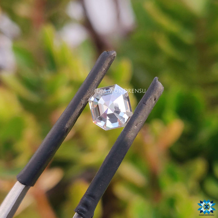 Off white moissanite shaped as asscher cut and listed as loose stone.