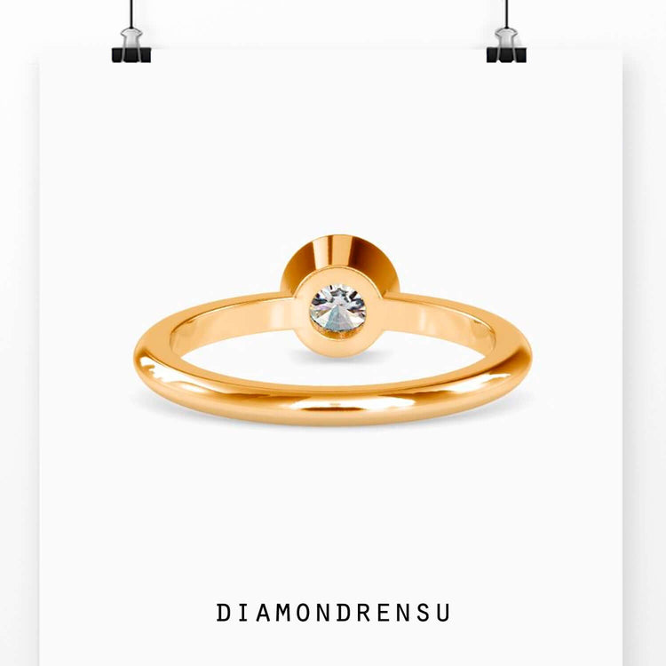 Elegant gold solitaire engagement ring featuring a round brilliant cut diamond.