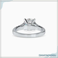 Round cut diamond engagement ring featuring a peek a boo diamond