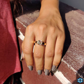 A gold solitaire engagement ring combining elegance with a warm golden hue.