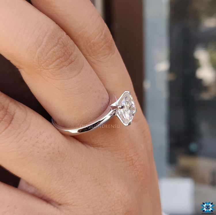 A classic round solitaire engagement ring set in a lustrous white gold engagement ring design.