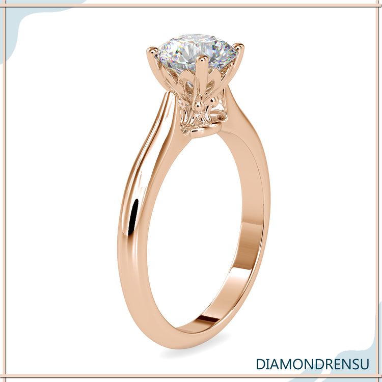 Diamond solitaire ring round with a classic knife edge design.