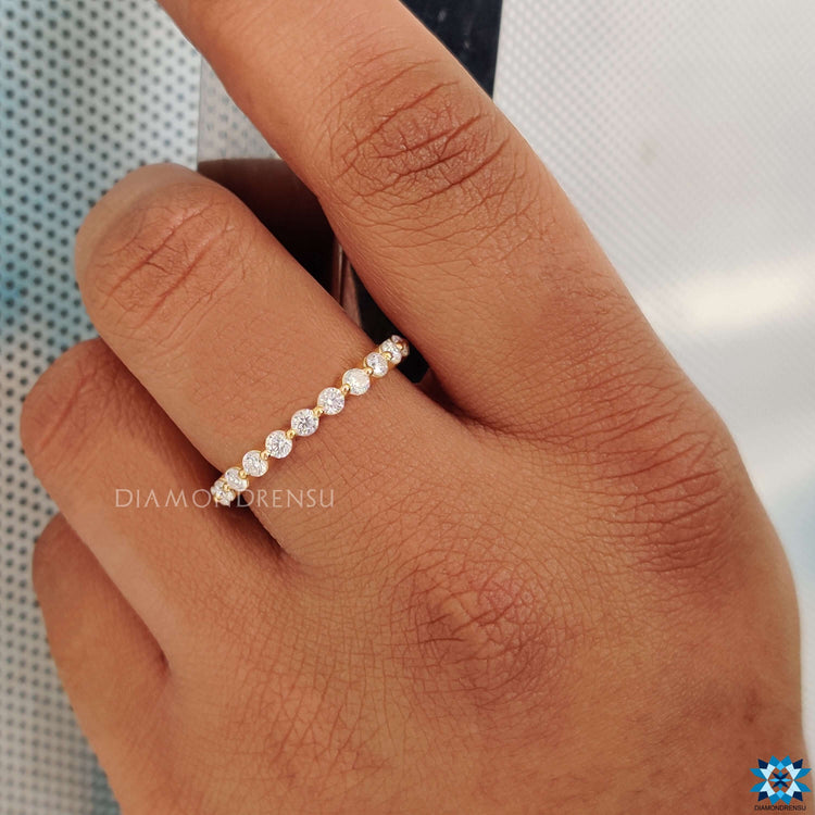 Round eternity band featuring sparkling, flawless gemstones.