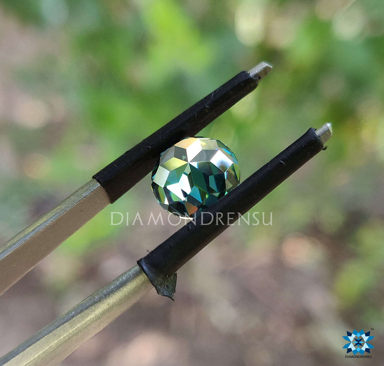 Moissanite 2 carat stone shown in rose cut design with green moissanite tones and brilliant detail.