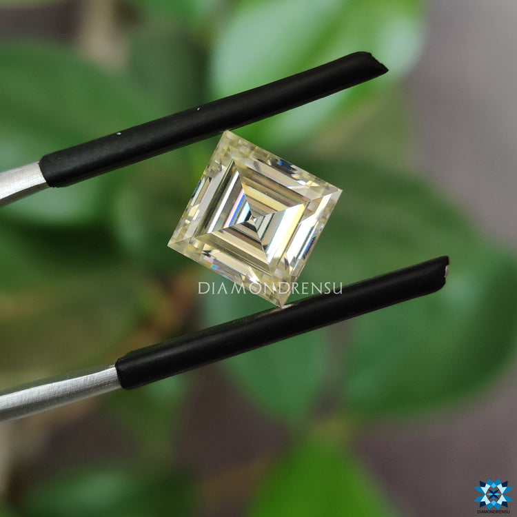 Loose moissanite stone next to 2.2 carat moissanite.