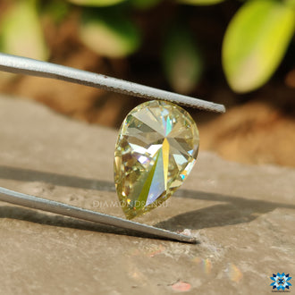 Greenish Yellow moissanite shown in pear shape for custom rings or pendants.