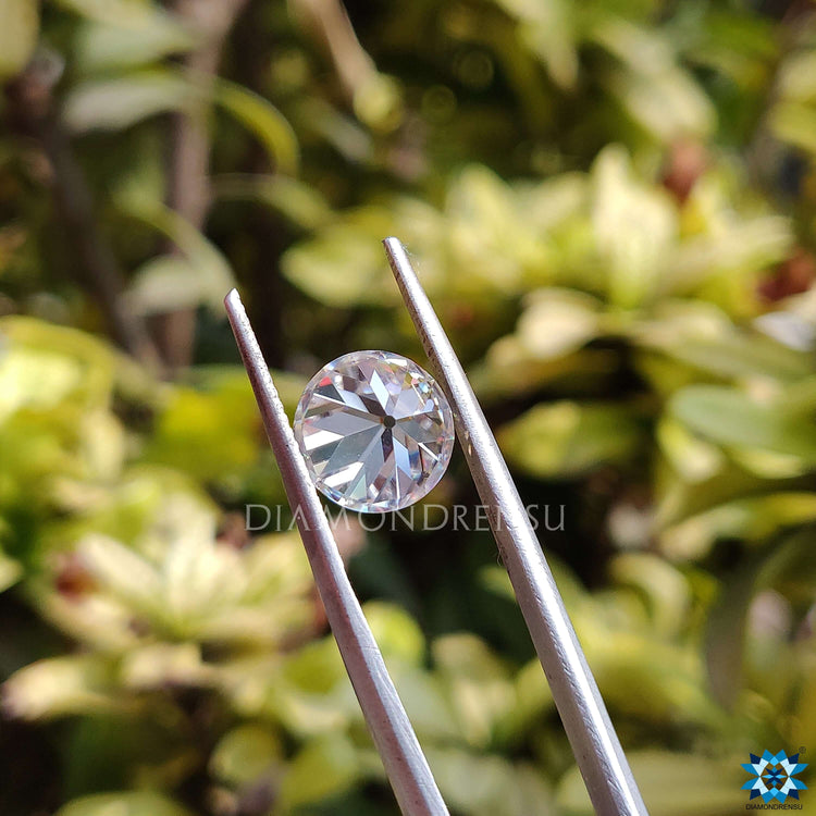 Antique cut moissanite loose stone in OEC round shape with clear colorless appearance.