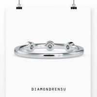 Three stone bezel ring with round diamonds in a yellow gold band