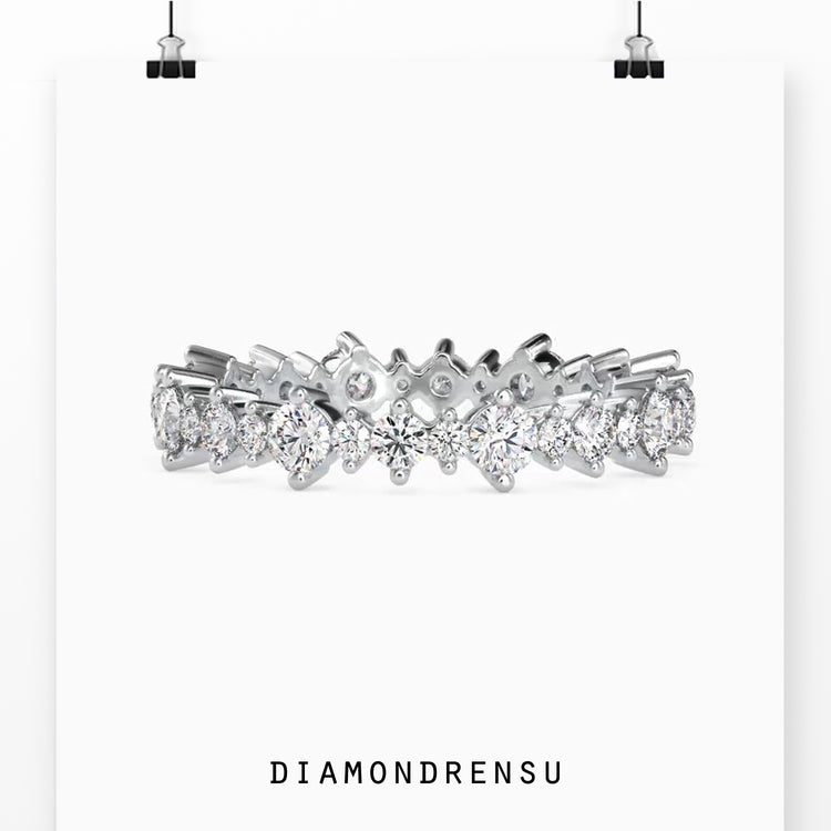 Full round wedding band featuring round cut diamonds in a 2 prong setting.