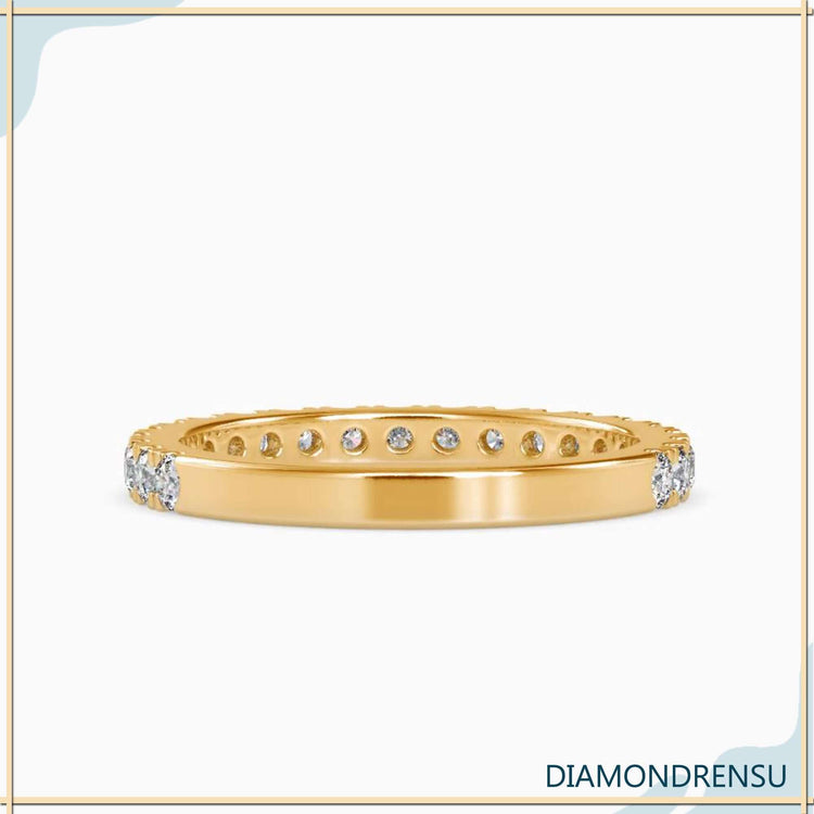Pave wedding band featuring rounded diamonds set in gold for a classic style.