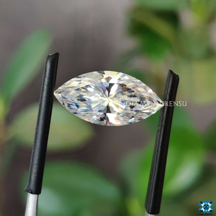Loose marquise stone beside moissanite stone glow.