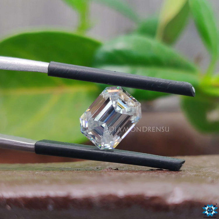 Moissanite loose stone offered in emerald cut and near colorless gray.