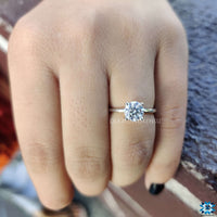 Colourless moissanite engagement ring sparkling under light