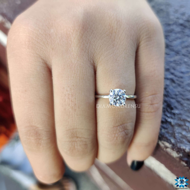 Colourless moissanite engagement ring sparkling under light
