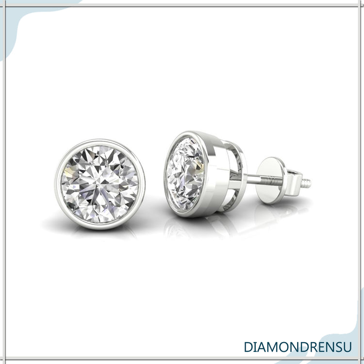 Stunning diamond earrings round set in white gold with bezel basket settings.