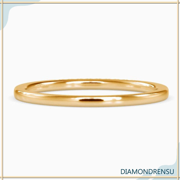 Lab Grown Diamond eternity wedding band in yellow gold with u prong setting.