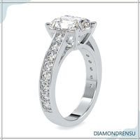 A radiant moissanite engagement ring paired with a channel set engagement ring band for a modern look.