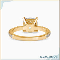 Pave diamond band with a cushion cut diamond ring in a four prong setting.