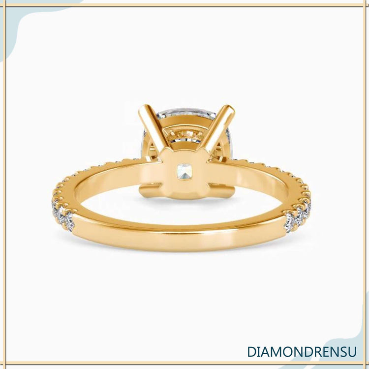 Pave diamond band with a cushion cut diamond ring in a four prong setting.