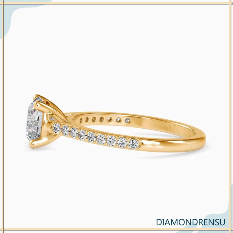 Round engagement ring with a pave setting and cathedral ring style, perfect for proposals.