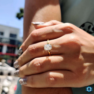 A handcrafted elongated cushion cut moissanite engagement ring in a claw prong setting.